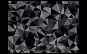 Dettaglio di tappeto moderno con motivo geometrico nero e grigio