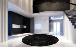 Tappeto moderno rotondo nero con piccoli motivi luminosi in un interno contemporaneo