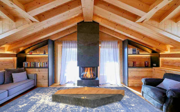 Tappeto moderno blu e crema effetto vissuto in un interno rustico con camino